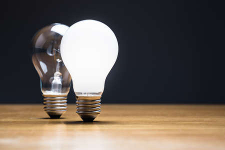 Two style light bulbs on the tableの写真素材