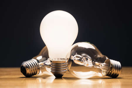 New Idea - Old Idea, comparative white light bulb standing on the table