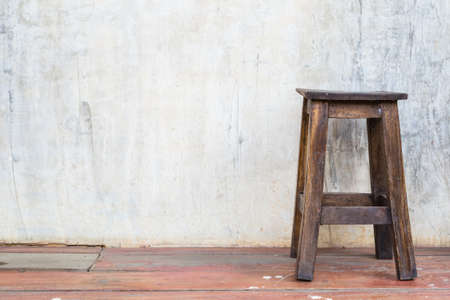 Old wood chair at the cement wallの写真素材