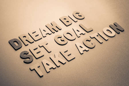 Wood letters arranged as Dream Big, Set Goal, Take Actionの写真素材