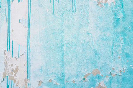 Old cement wall with green chipped paintの写真素材