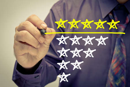 Businessman underline five stars rating on screenの写真素材
