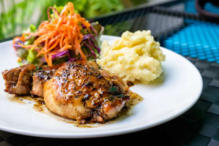 Kurobuta pork steak with mash potato and saladの写真素材