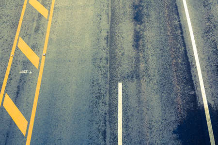Asphalt road lane with traffic lines, almost dry after the rain, top viewの写真素材