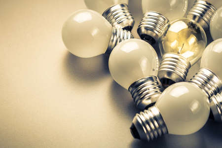 Small light bulbs and the different one glowing in the group, small business, original idea conceptの写真素材