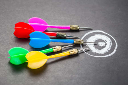 Many darts aim on chalk drawing target, goal setting, competition or trend conceptの写真素材