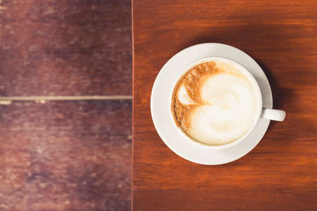 Cup of Cappuccino on wood table, top viewの写真素材
