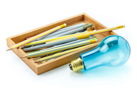 Creative Writing, light bulb and many pencils in wood box isolated on white backgroundの写真素材
