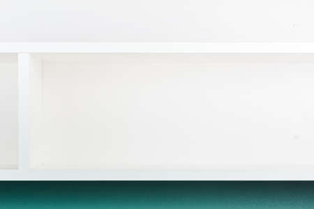 Empty white shelf on the wall