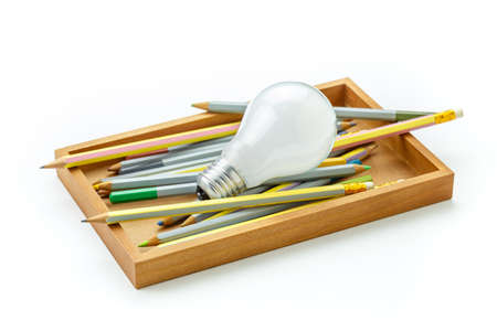 Creative Writing, light bulb and many pencils in wood box isolated on white backgroundの写真素材