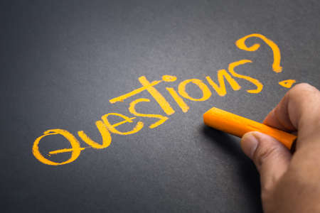 Hand writing Questions word on chalkboardの写真素材