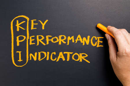 Hand writing KPI or Key Performance Indicator on chalkboard