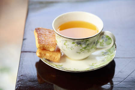 Cup of tea on the table with sugar biscuitsの写真素材