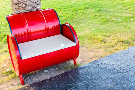 Red bench in the park, adapted from gasoline tank and wood windowの写真素材