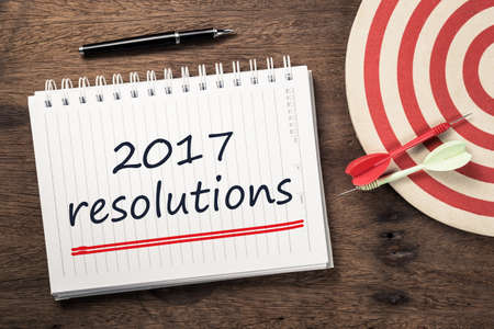 2017 Resolutions text on notebook with dart and dartboardの写真素材