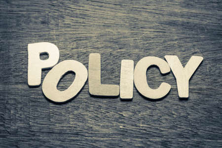 Wood letters of Policy word on wood backgroundの写真素材