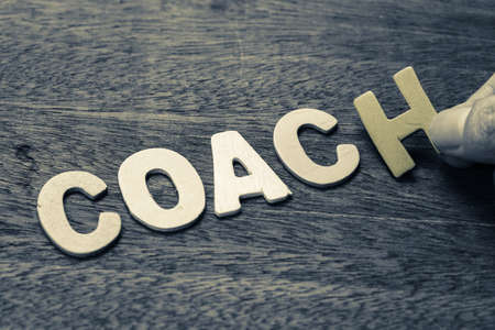 Hand arrange wood letters as Coach wordの写真素材