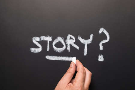 Hand writing Story topic on chalkboardの写真素材