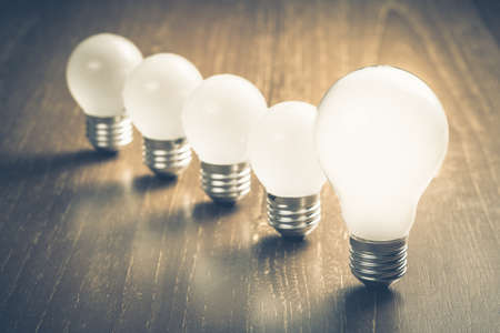 Bigger light bulb in front of the row of small bulbs