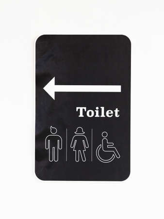 Toilet sign with icon of gender and handicap on white wallの写真素材