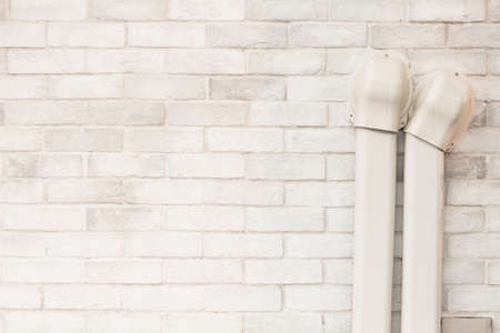 White brick wall with air-conditioner tube linesの写真素材