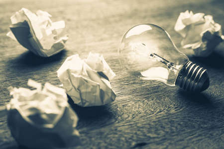 Usable Idea, closeup light bulb in the group of crumpled ball paperの写真素材