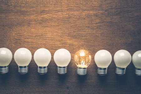 Different light bulb glowing in the row