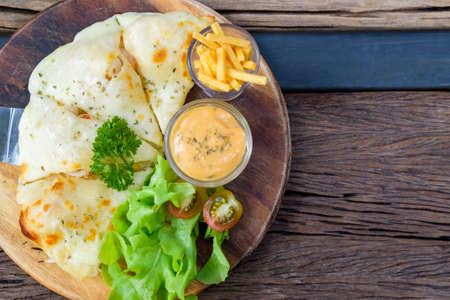 Pizza with Thousand Island Sauce on round wood plateの写真素材