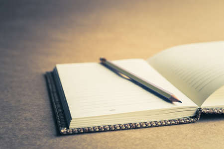 Pencil on opened notebook, retro color styleの写真素材