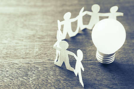 Human chain paper with light bulb, team for success conceptの写真素材