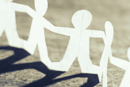 Participate in teamwork, closeup one of human chain paperの写真素材