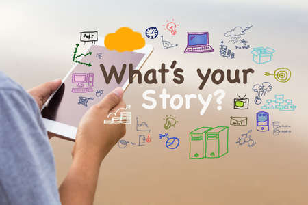 What's Your Story text with drawing icon on the background of woman reading tabletの写真素材