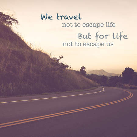 Inspiration quote (We travel not to escape life But for life not to escape us) on vintage photo,  road on the mountainの写真素材