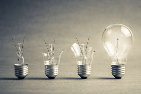 Broken light bulb step to the perfect one, failure to success, improvement ideaの写真素材
