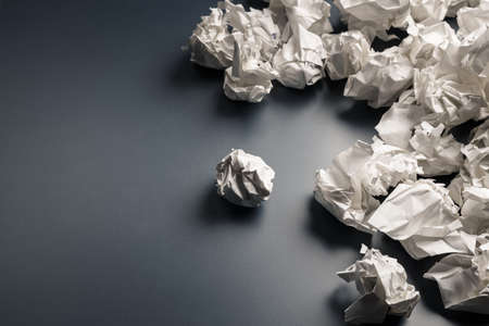 Many crumpled paper balls on gray backgroundの写真素材