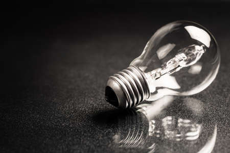 Light bulb with reflection on black backgroundの写真素材
