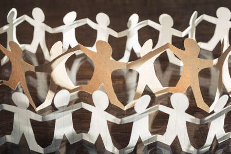 Row of human paper chain dolls, social connection conceptの写真素材