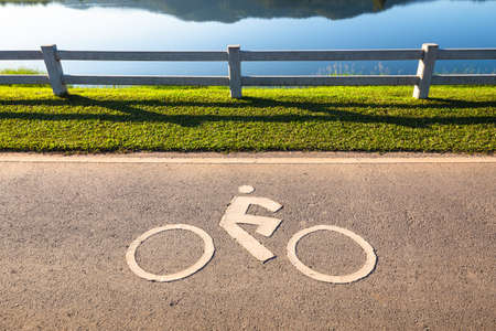 Bike land icon on asphalt road in the parkの写真素材