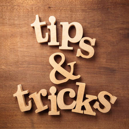 Tips and Tricks by wood alphabet on wood backgroundの写真素材