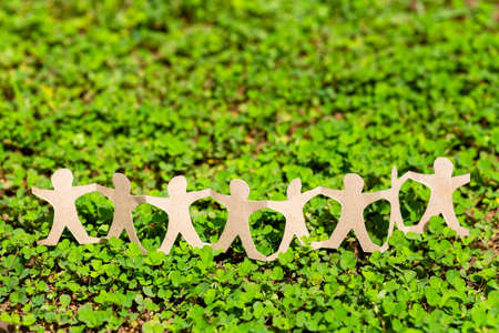 Human chain paper on green creeper plant, CSR (coporate social responsibility) or teamwork concept