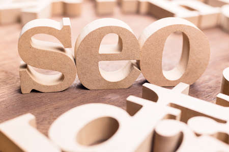 SEO abbreviation by wood alphabet scattered on the tableの写真素材