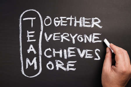 Hand writing text and acronym of TEAM word on chalkboardの写真素材