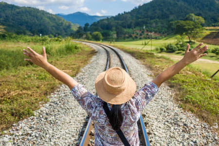 Woman feel free while walk along the railway in countrysideの写真素材