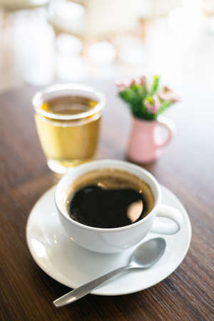 Black coffee served on the table with tea waterの写真素材