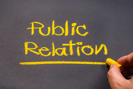 Hand writing text PUBLIC RELATION on chalkboardの写真素材