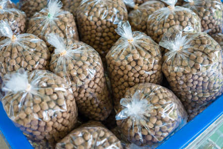 Closeup fish food pellets in plastic bag for sale