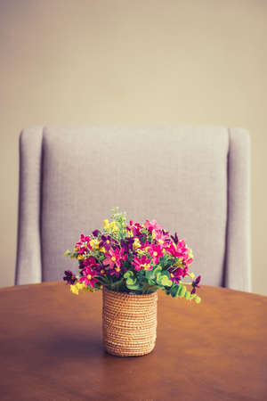Artificial flowers bouquet on the dinning table, vintage color styleの写真素材