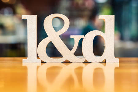 L&D wood alphabet set on the table as the abbreviation of Learning and Development, shallow depth of field to blur backgroundの写真素材