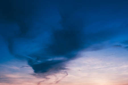 Deep blue clouds on faded sky at duskの写真素材