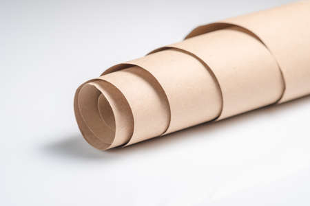 Closeup roll of packaging brown paper, parcel wrapping paper on whiteの写真素材